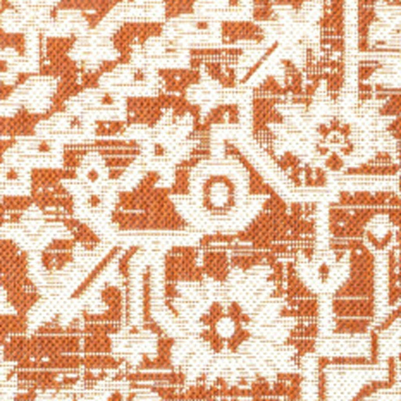 Orange and cream medallion rug detail with ornate corner motifs and lattice lines