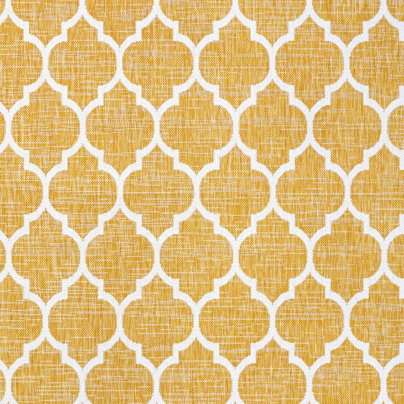 Yellow area rug with cream trellis quatrefoil pattern