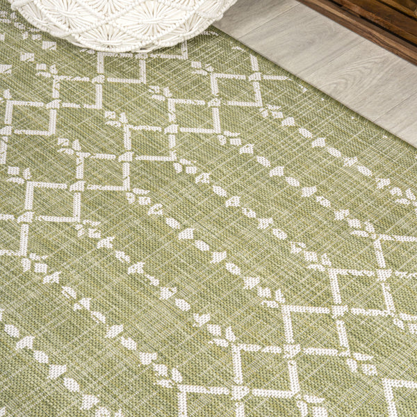 Light green indoor/outdoor area rug with cream square trellis pattern