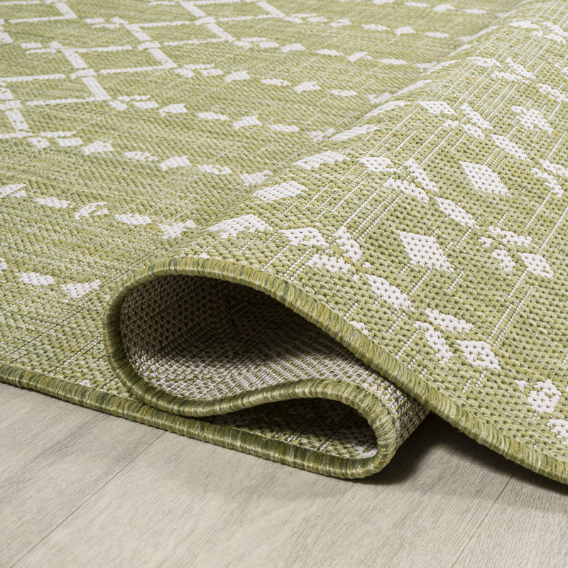 Light green square trellis rug with cream pattern; rolled edge detail