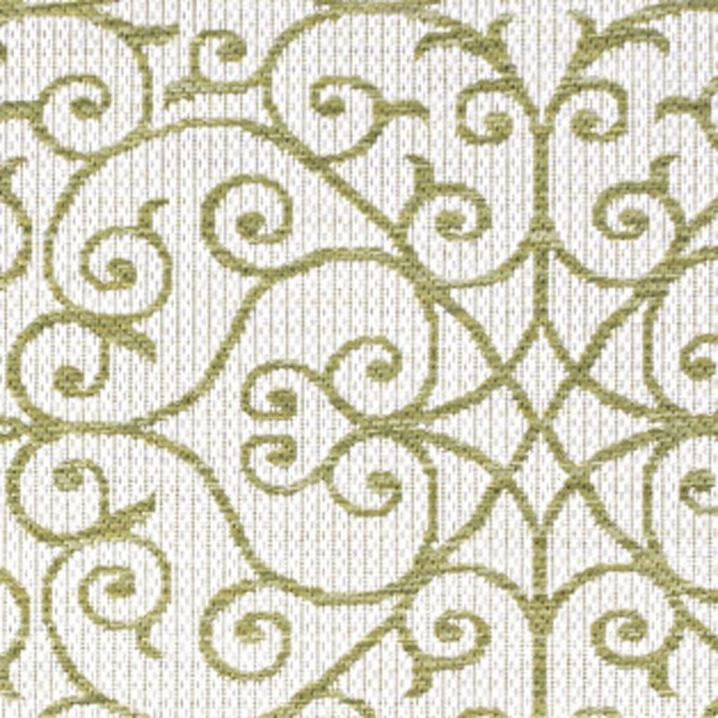 Indoor-outdoor area rug close-up, cream texture with green swirling vines