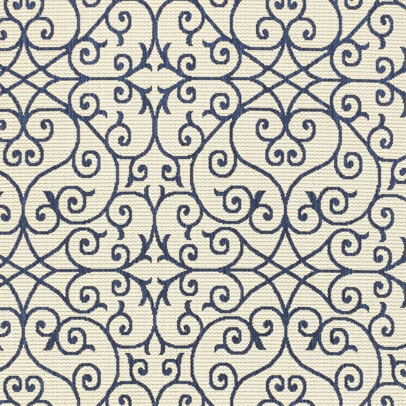 Close-up of navy geometric scroll pattern on beige indoor outdoor rug