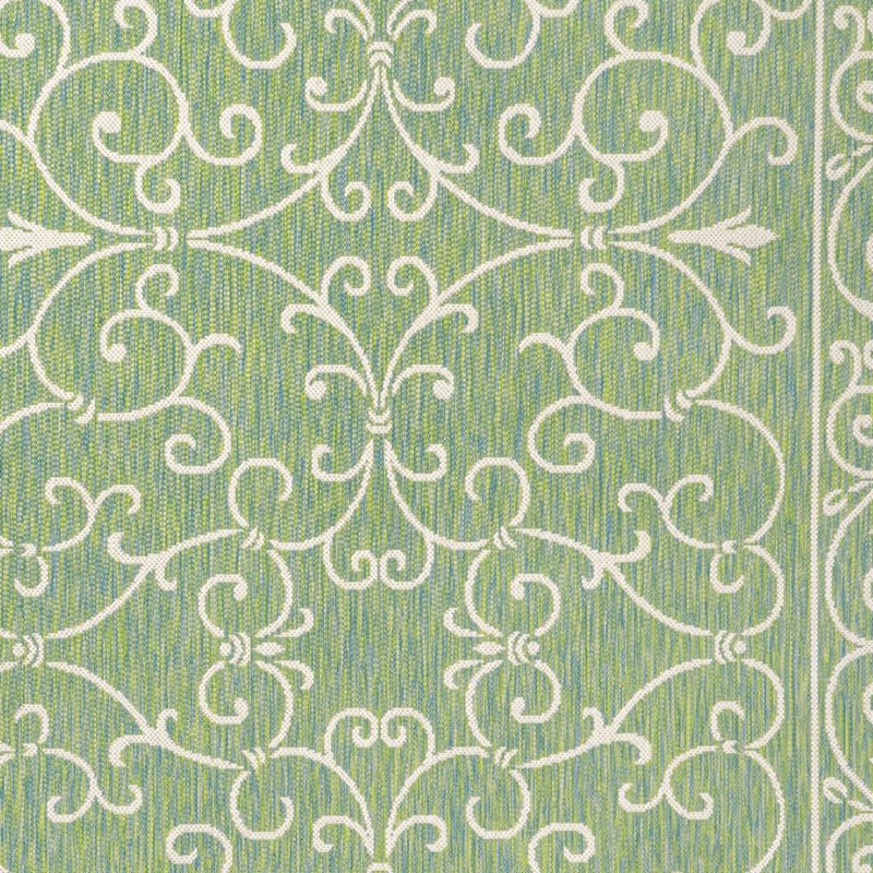 Green rug with close-up ivory vine scroll medallion motif