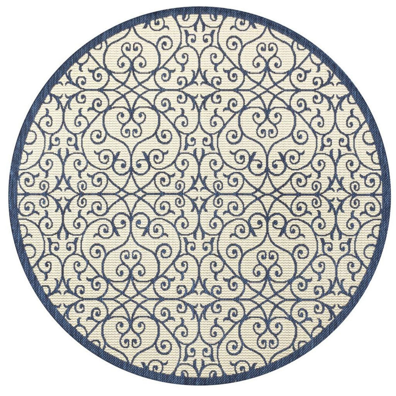 Round rug with repeating navy floral scroll motifs on beige surface