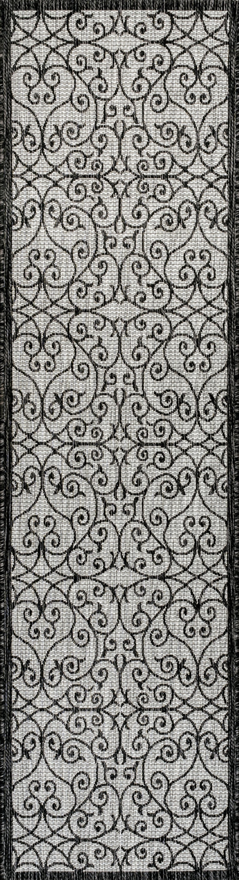 Light gray and black geometric runner rug with ornate lattice swirl design