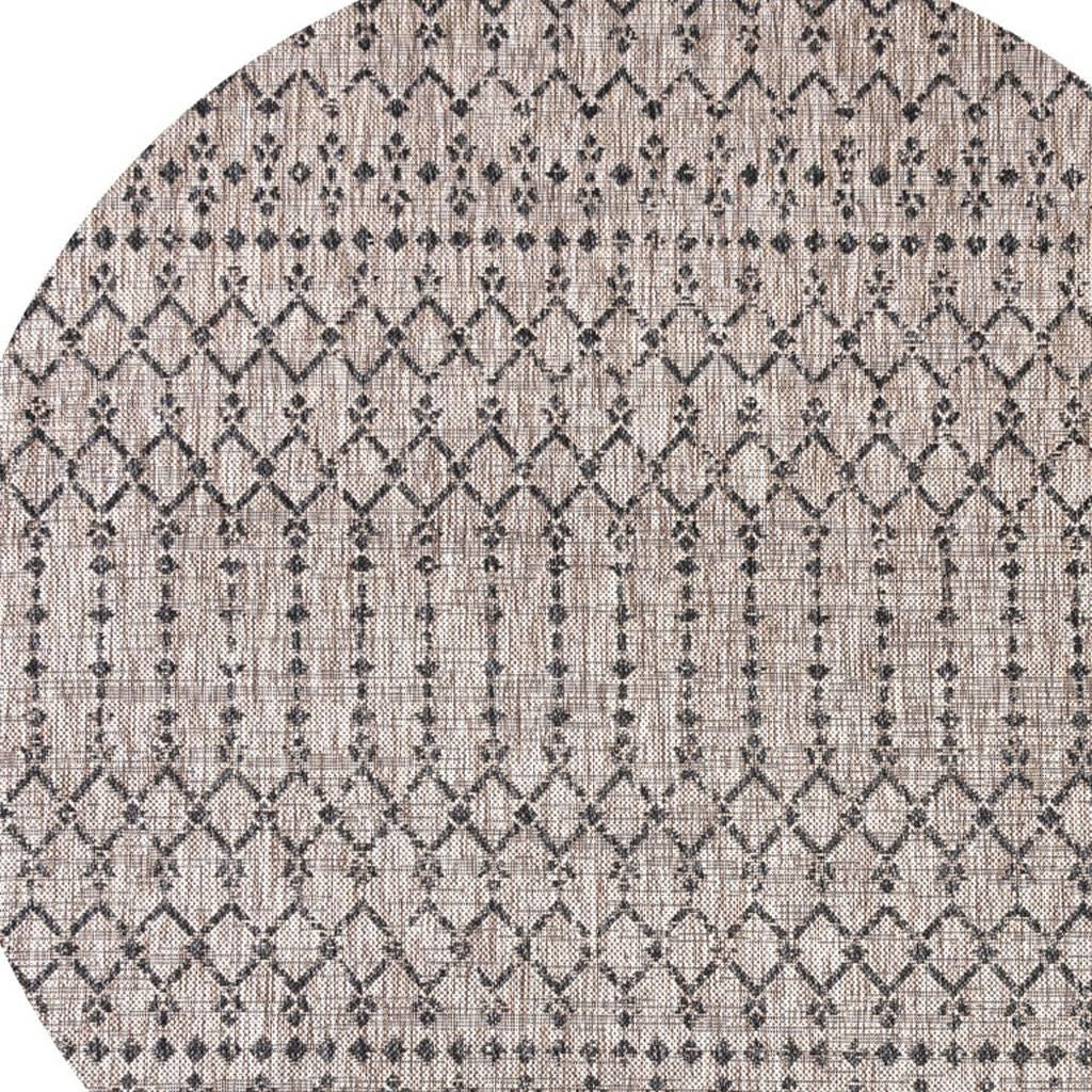 Round indoor/outdoor area rug with beige base and black trellis diamond pattern.