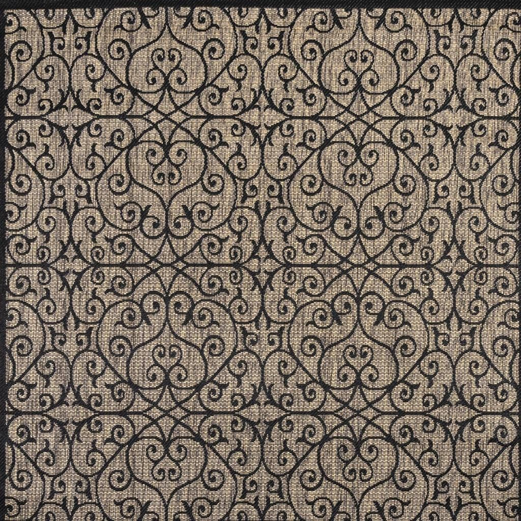 Black-and-khaki patterned area rug with intricate swirling medallion design