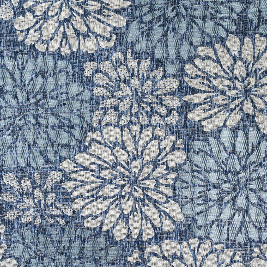 Blue rug with repeating cream floral burst motifs