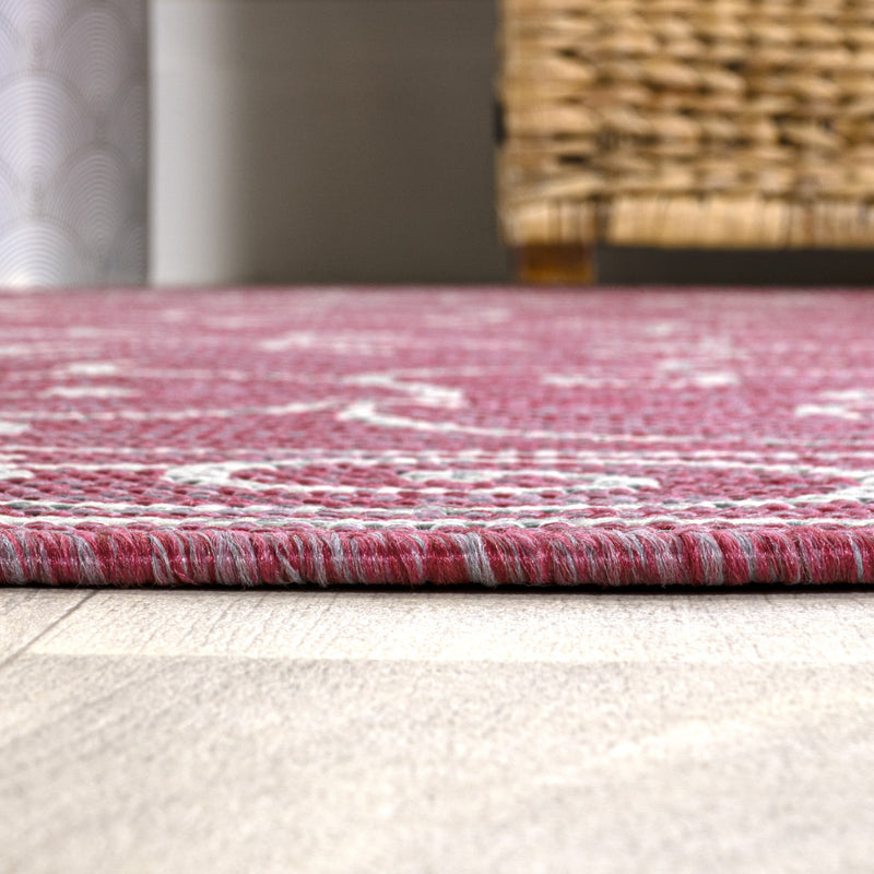 Fuchsia area rug edge with light gray woven trim and textured multi-tone weave
