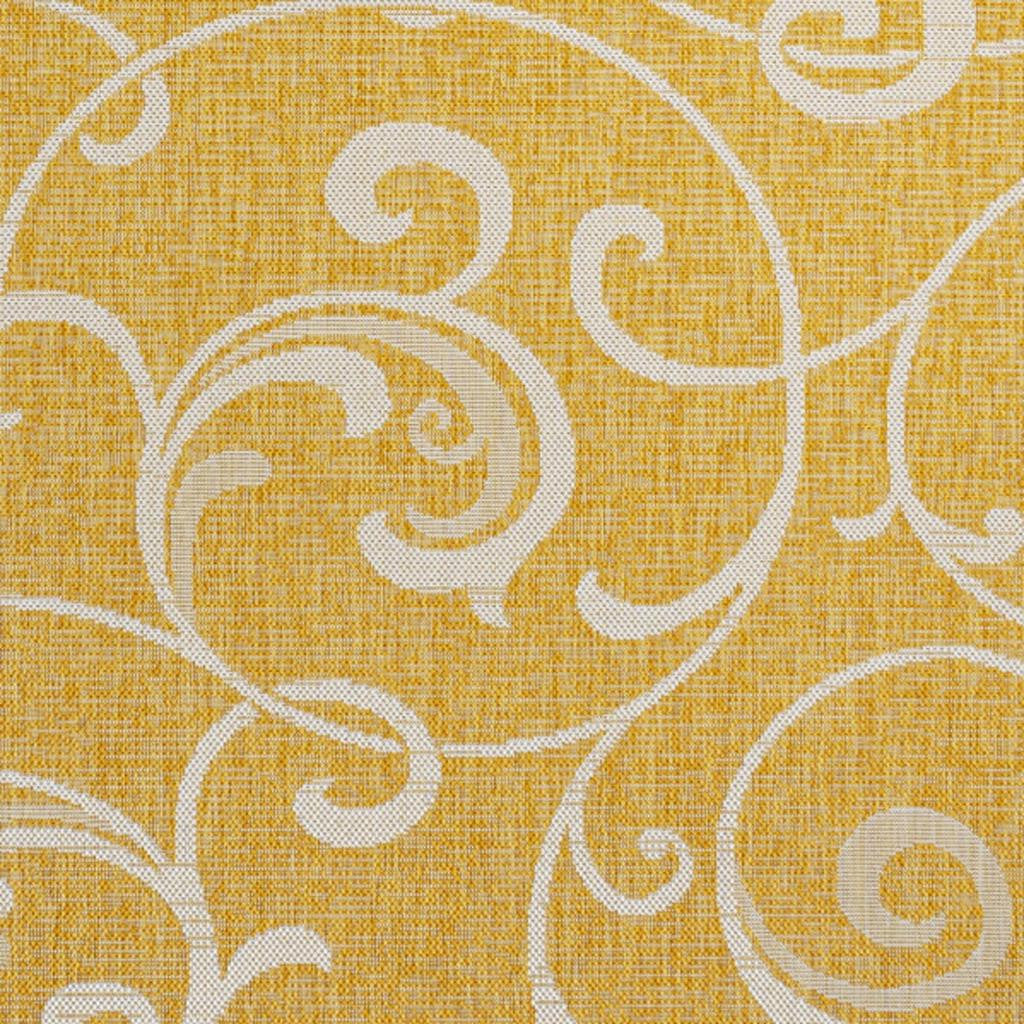 Yellow rug with cream filigree scrollwork