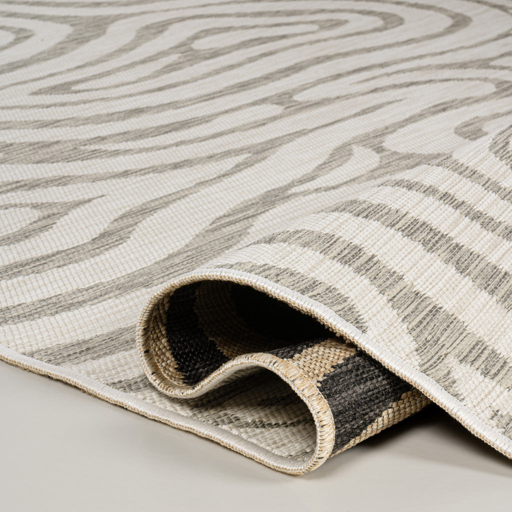 Gray and cream abstract indoor/outdoor runner rug with rolled corner and woven border