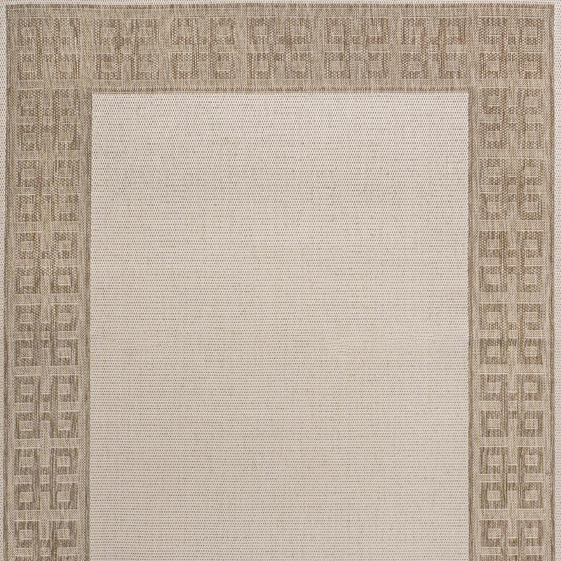 Cream area rug close-up with Greek key border and micro-textured center