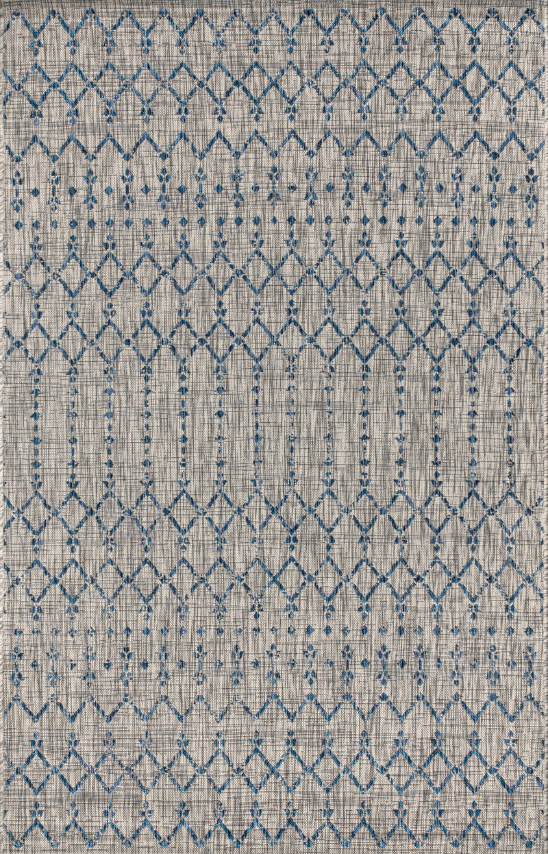 Close-up light gray rug with blue and navy trellis diamond lattice pattern