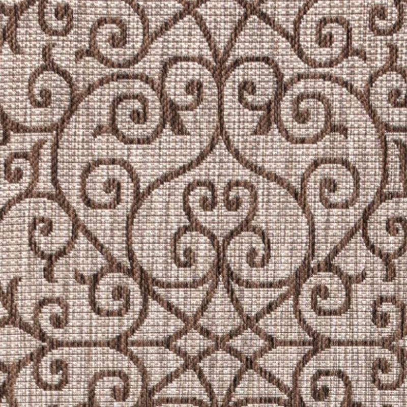 Close-up taupe and espresso geometric rug texture with swirling ornamental pattern