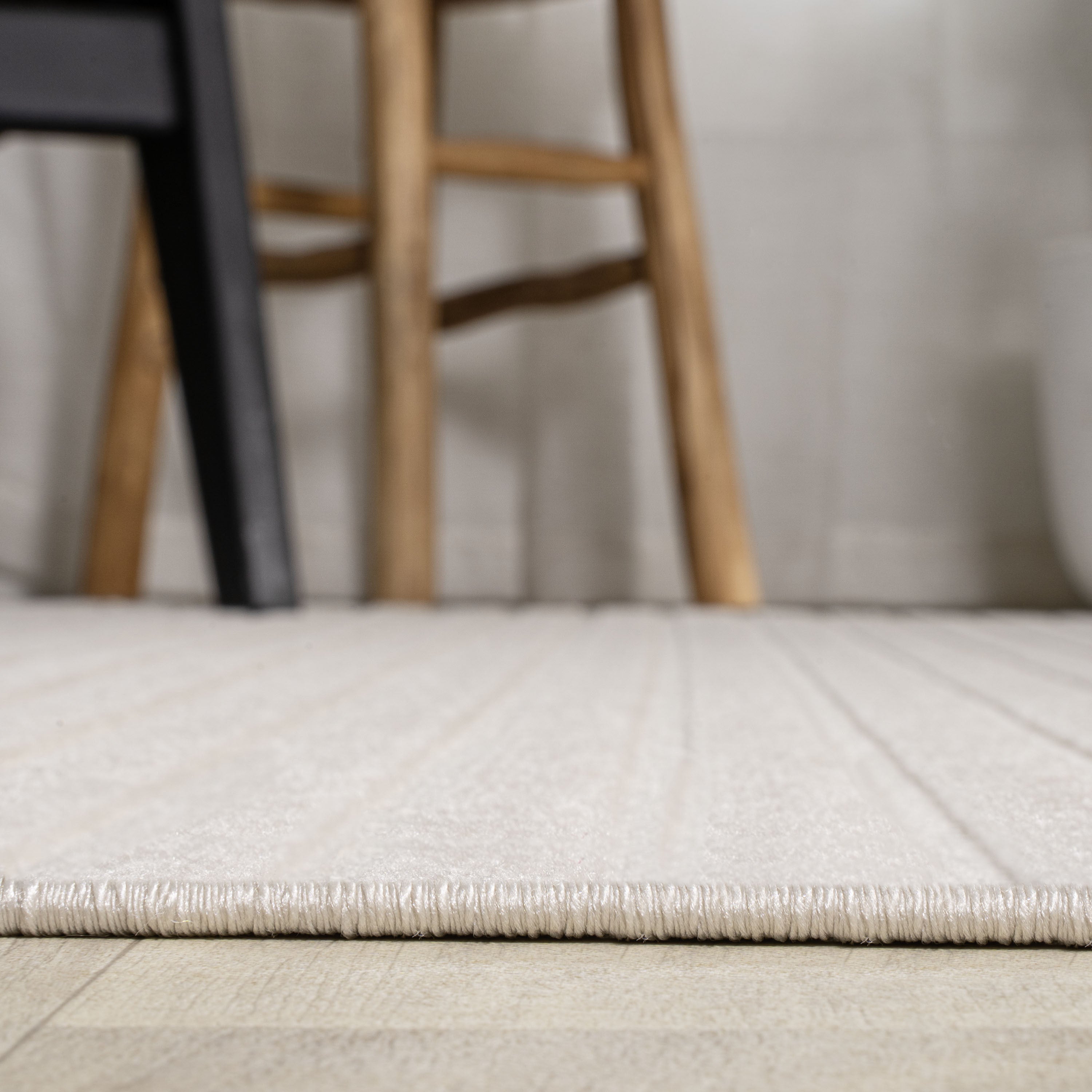 Ivory and cream rug pile close-up with smooth low-profile woven texture