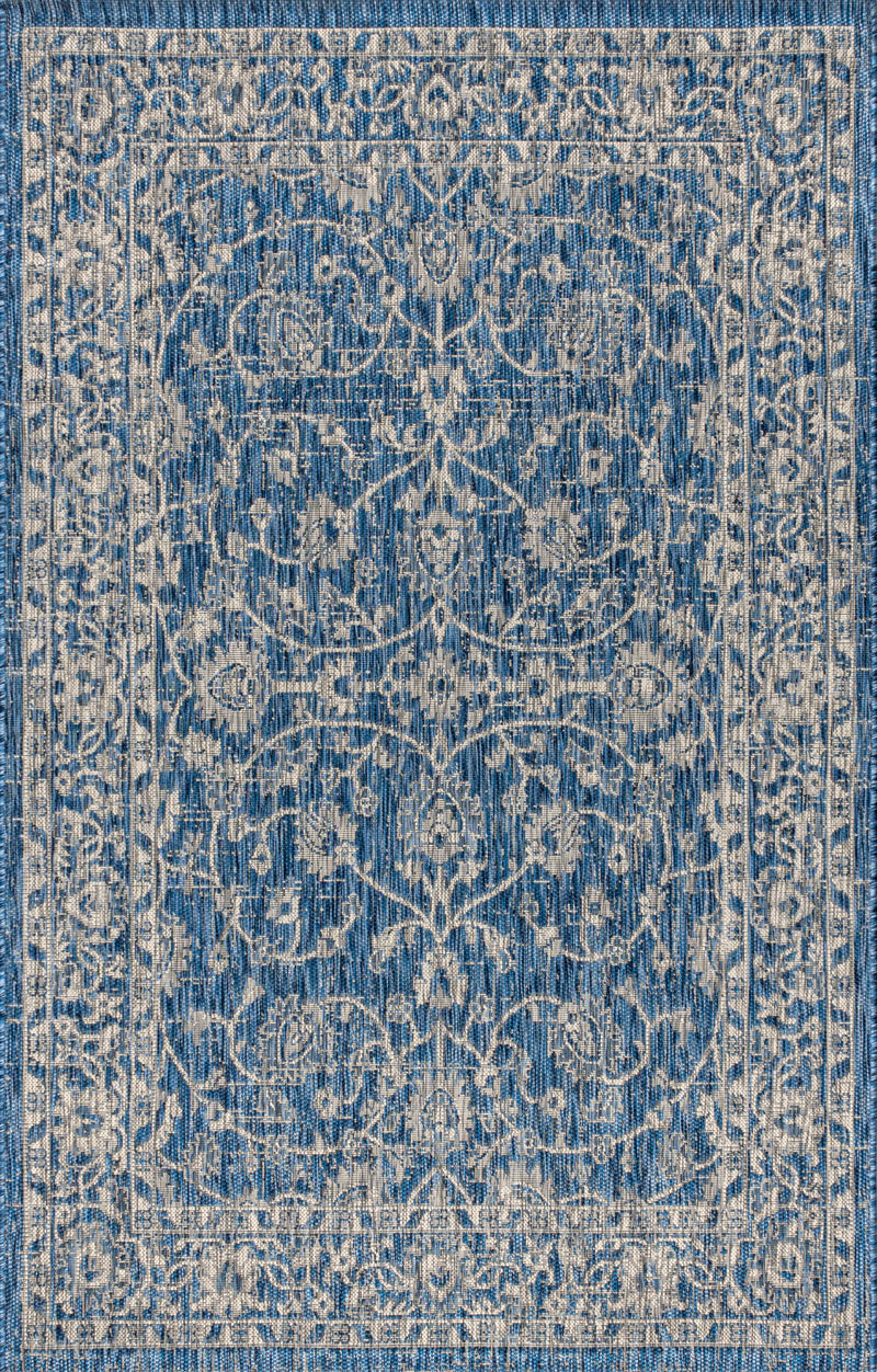 Close-up of navy and gray medallion area rug with intricate damask-style motif