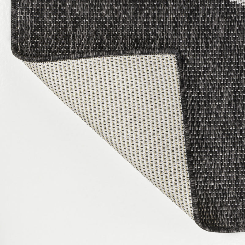 Black and cream geometric area rug with textured woven edge