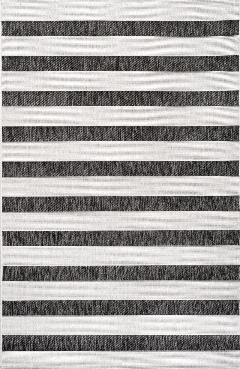 Striped area rug close-up with black and cream horizontal bands
