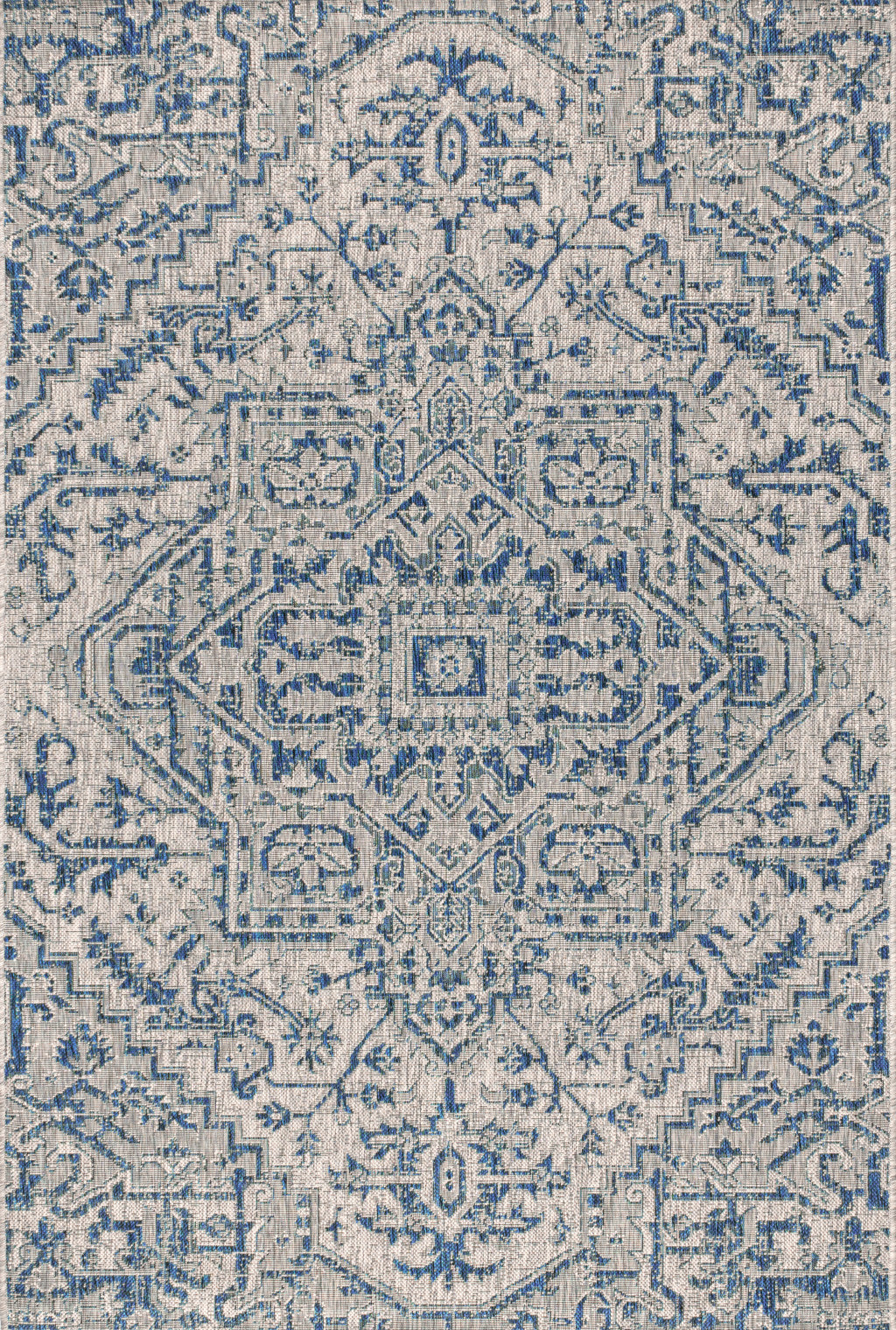 Close-up of blue and gray medallion rug with detailed geometric motifs