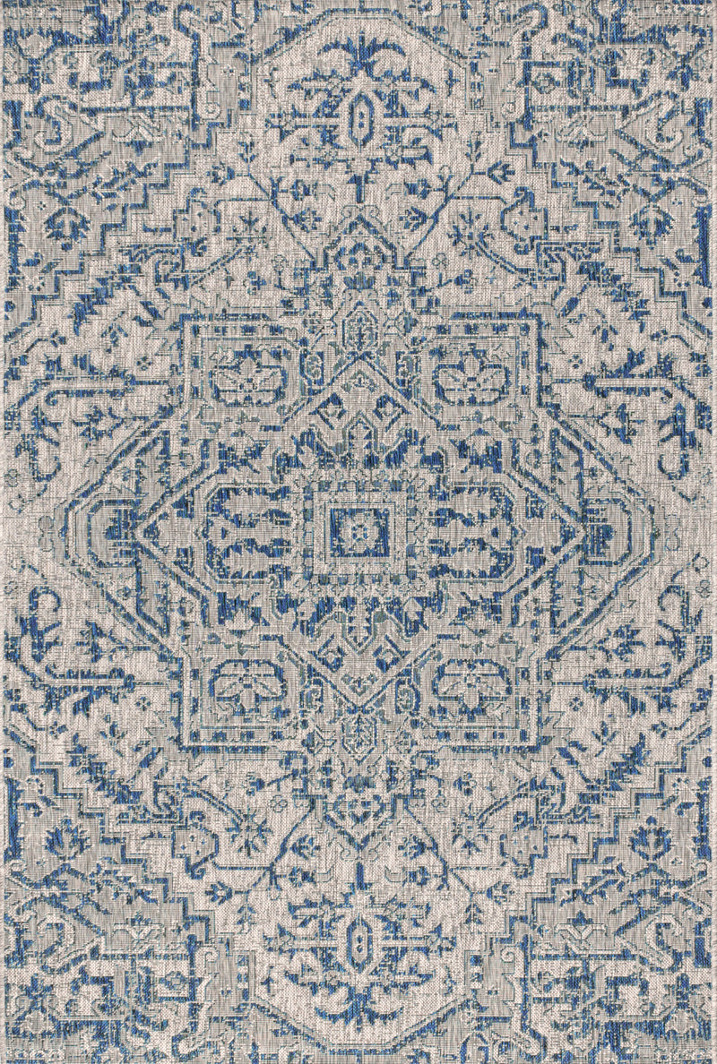 Close-up of blue and gray medallion rug with detailed geometric motifs