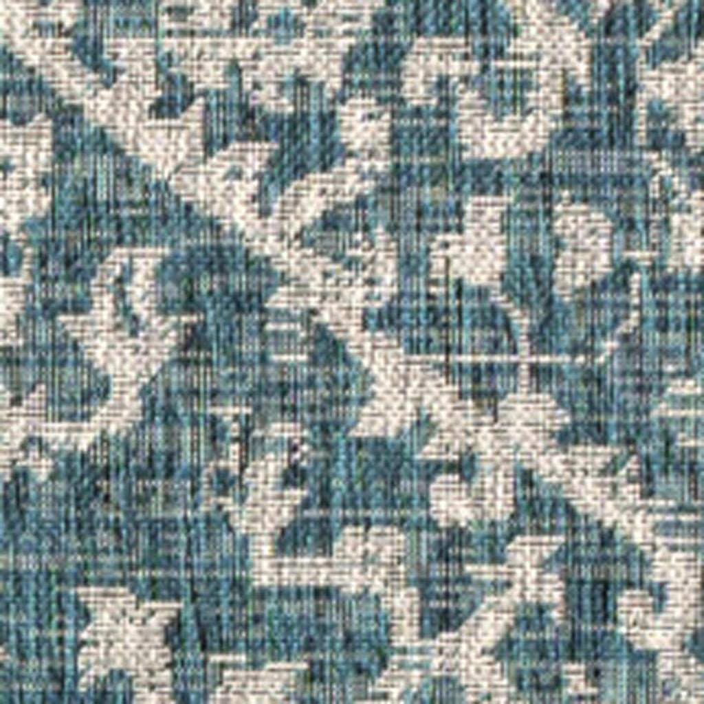 Teal blue and gray medallion area rug, close-up geometric pattern