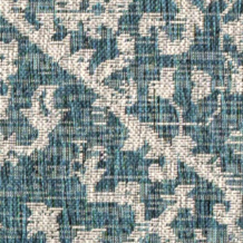 Teal blue and gray medallion area rug, close-up geometric pattern