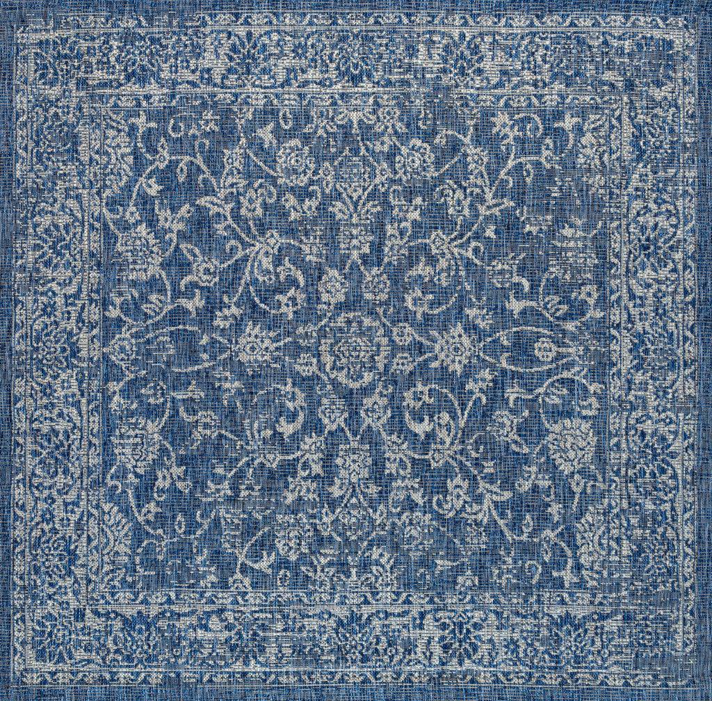 Square blue area rug with centered ivory medallion and detailed distressed border