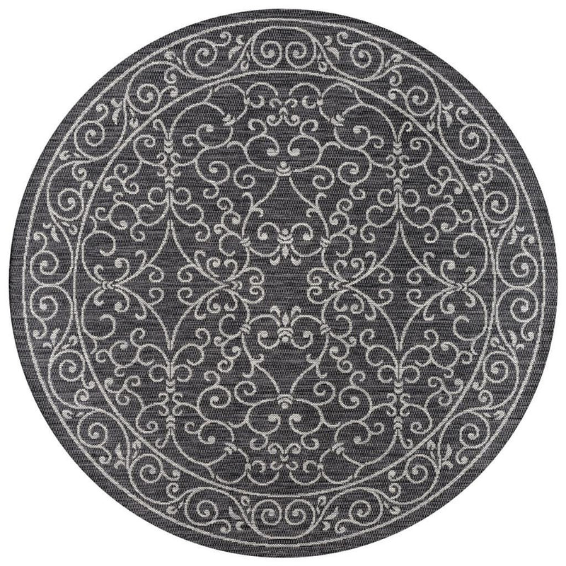 Round area rug in dark gray with ornate light gray medallion pattern