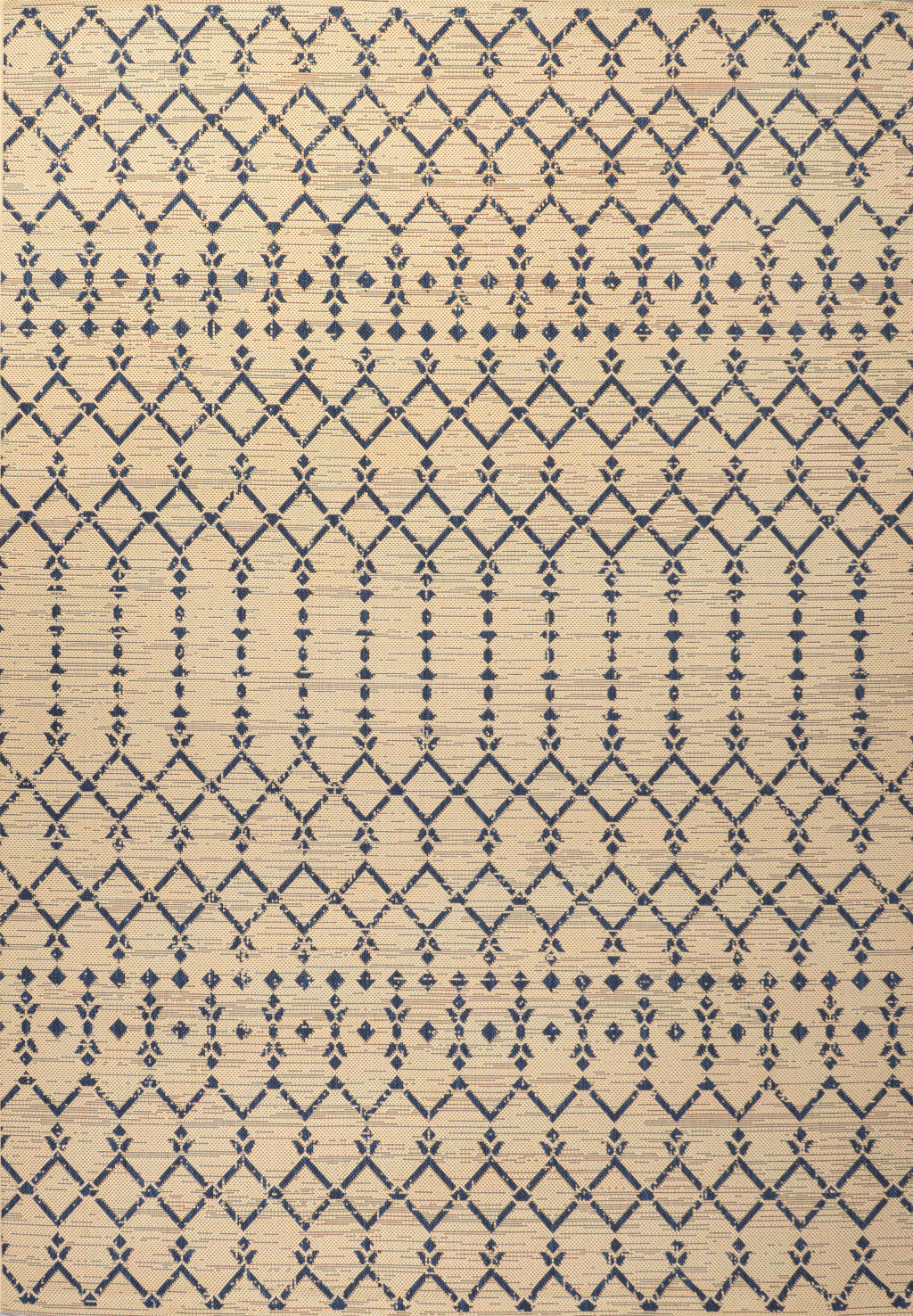 Beige rug close-up with navy trellis geometric diamonds and lines pattern