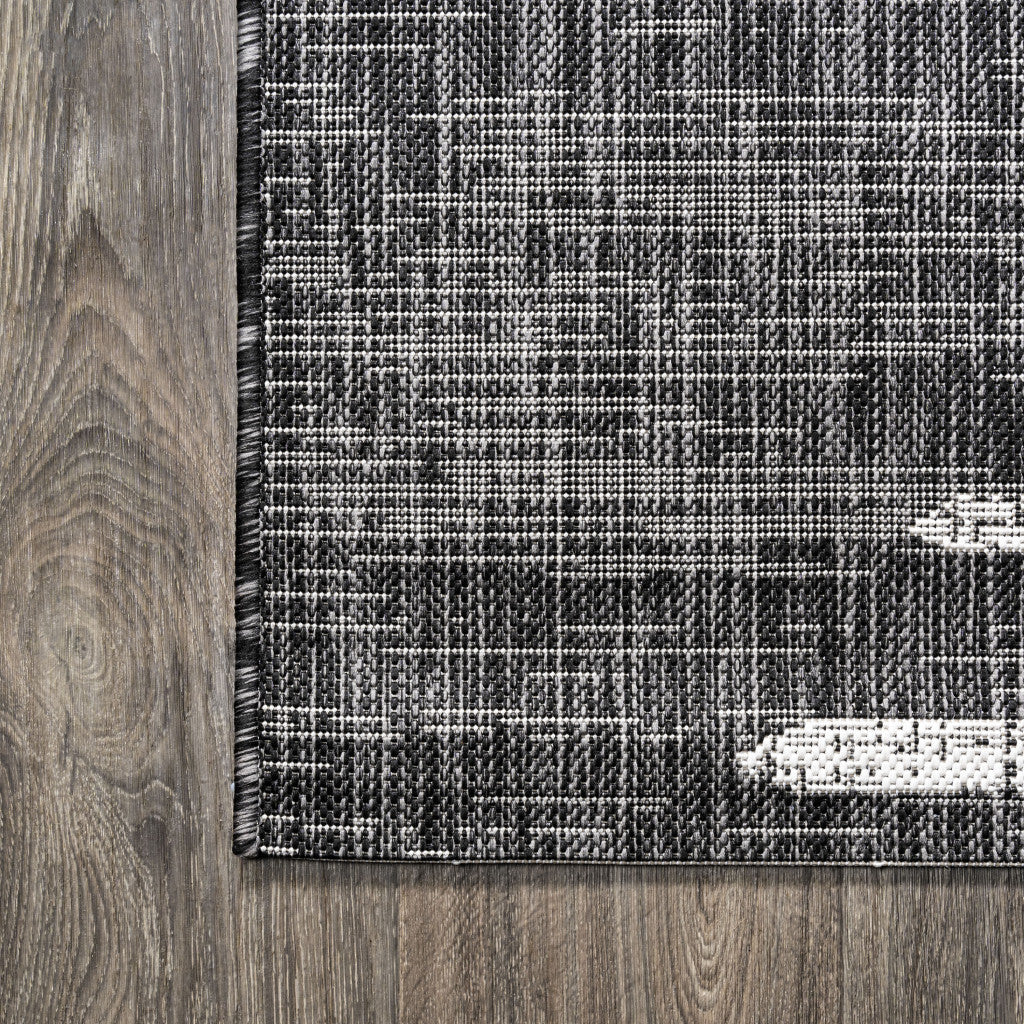 Black rug panel with ivory horizontal stripes and stitched edge, close-up