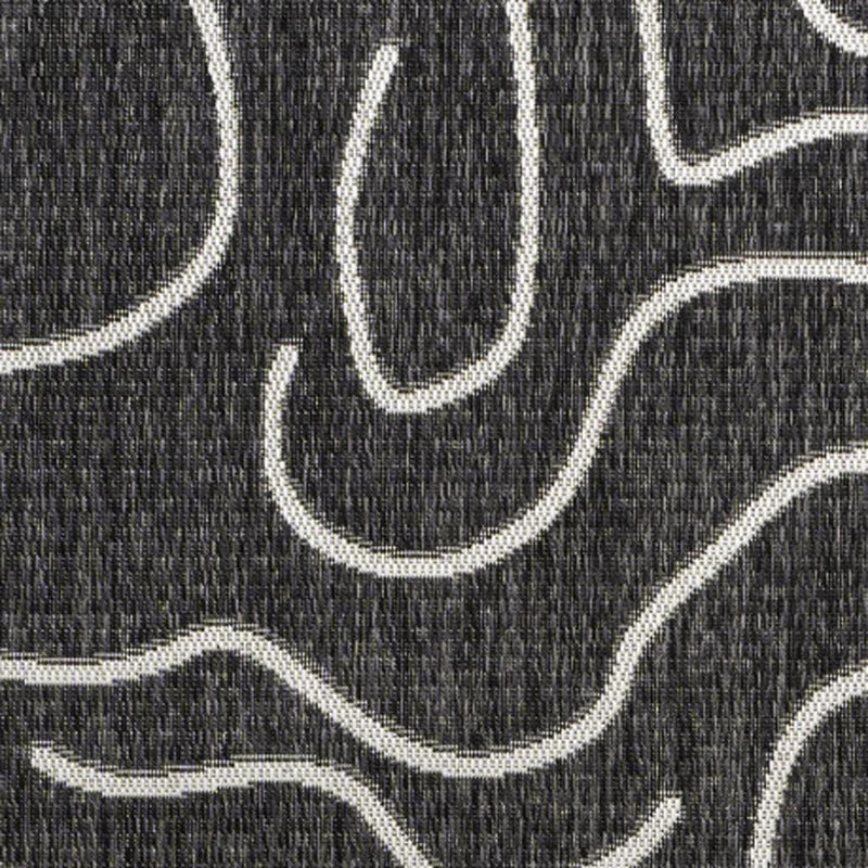 Close-up of black area rug texture with cream abstract contour lines