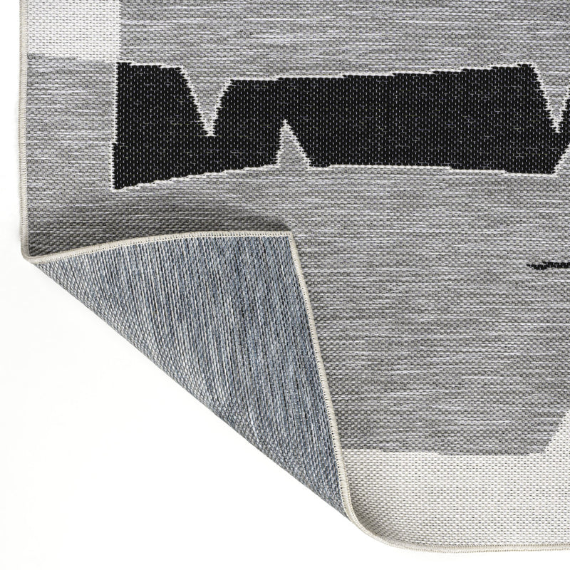 Gray and cream abstract runner rug corner with woven border and underside