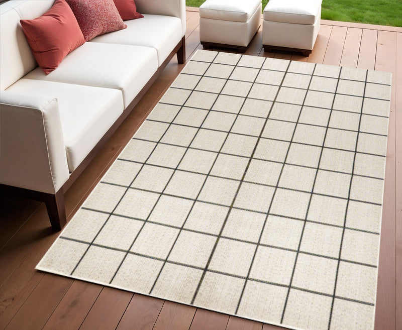 Cream and dark gray plaid area rug laid on a floor with visible border.