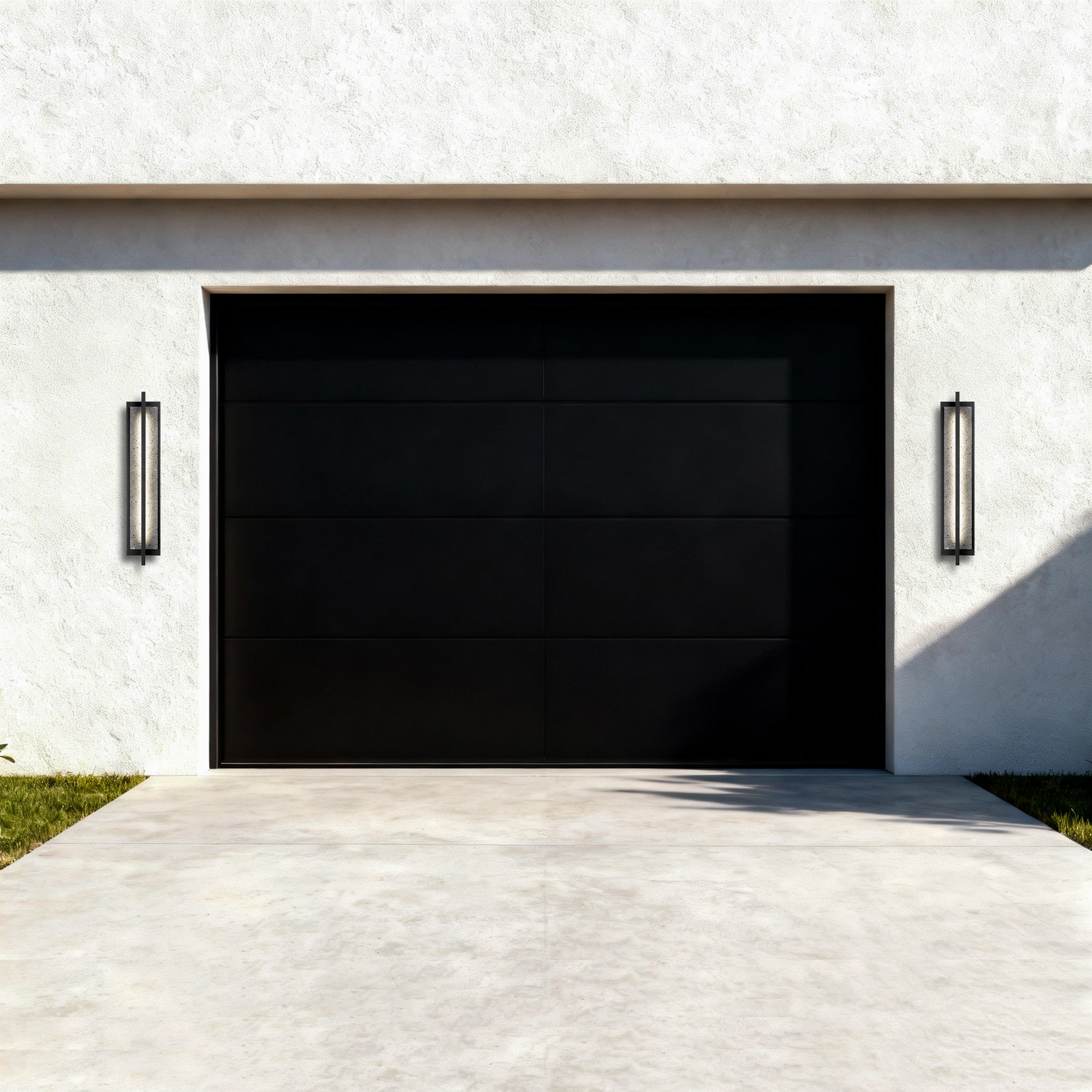 Two black LED outdoor rectangular wall lights with speckled glass panels near garage doors