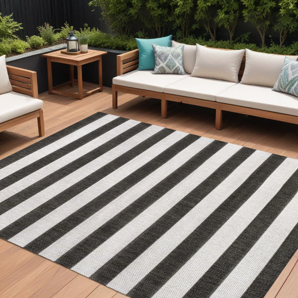 Indoor/outdoor striped area rug with bold black and cream horizontal bands