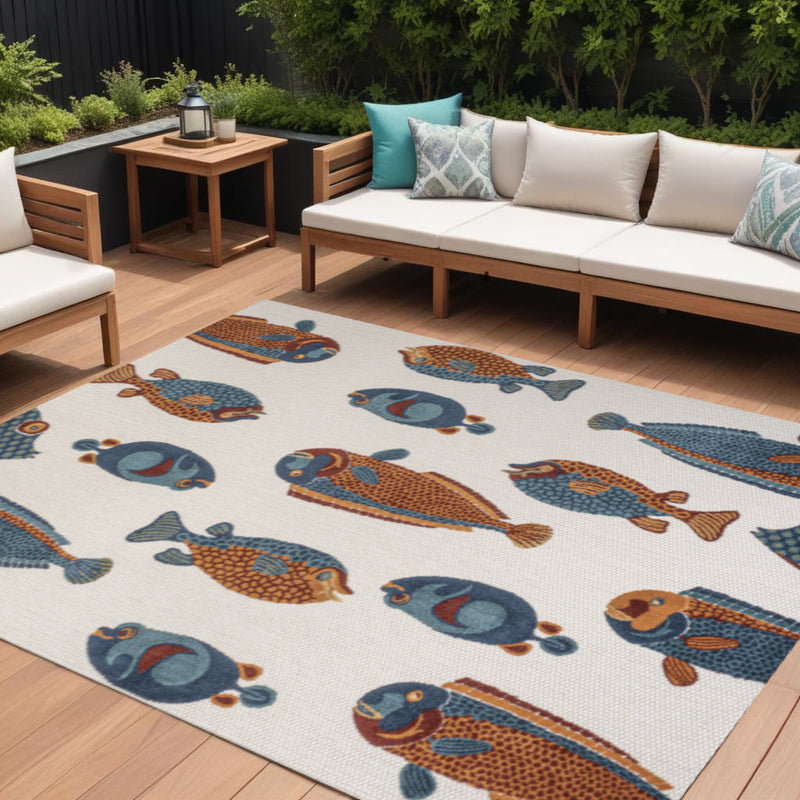 Cream indoor outdoor area rug with navy blue and orange animal print, full view