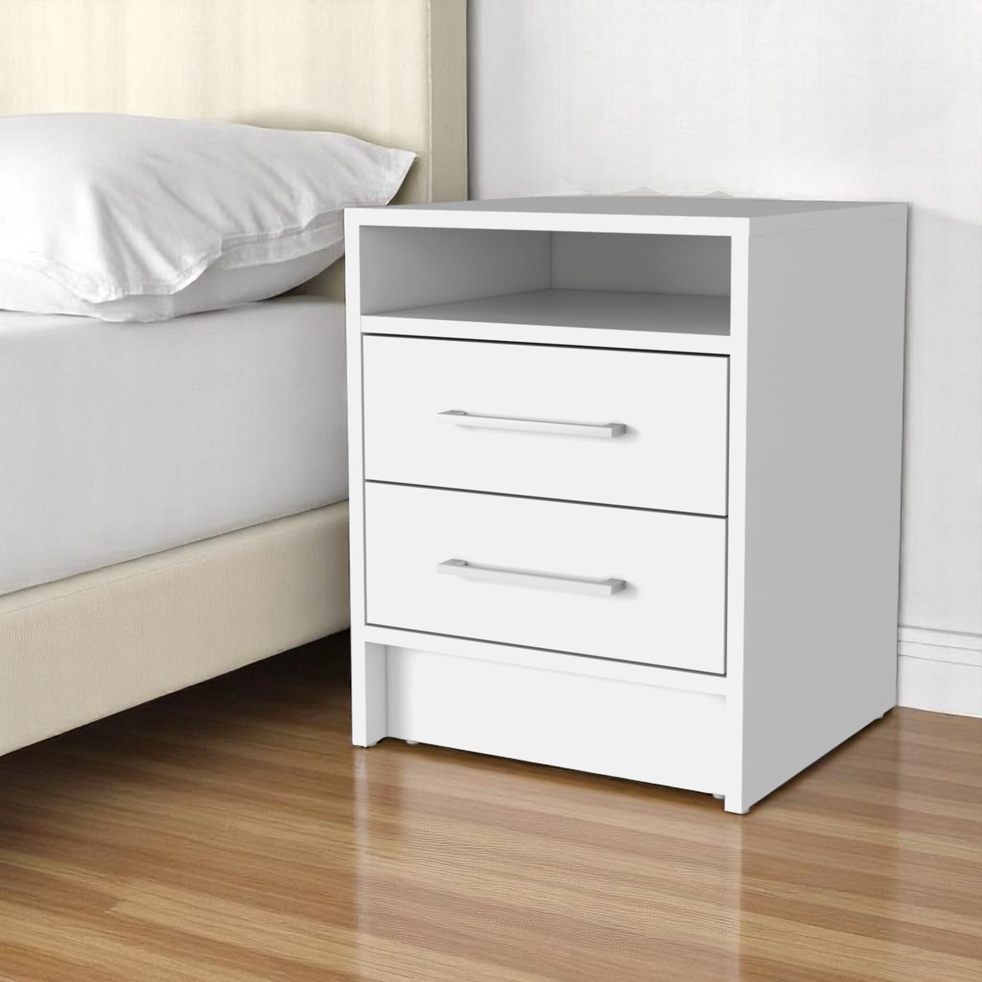 White wood nightstand next to bed, front view with open shelf and two drawers