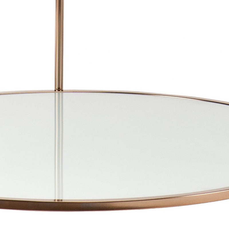 Round coffee table with clear glass and gold iron frame, showing central support and rim