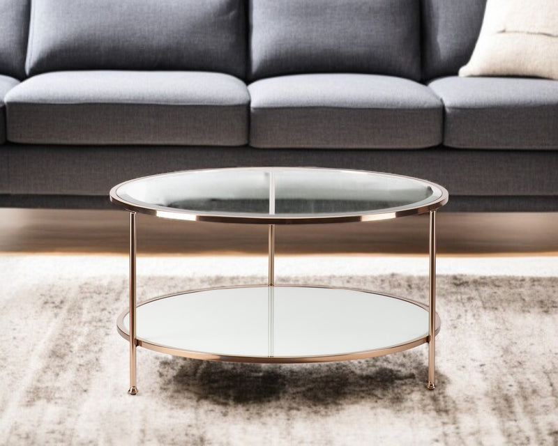 Round clear glass coffee table with gold iron frame and two-tier glass shelves in living room