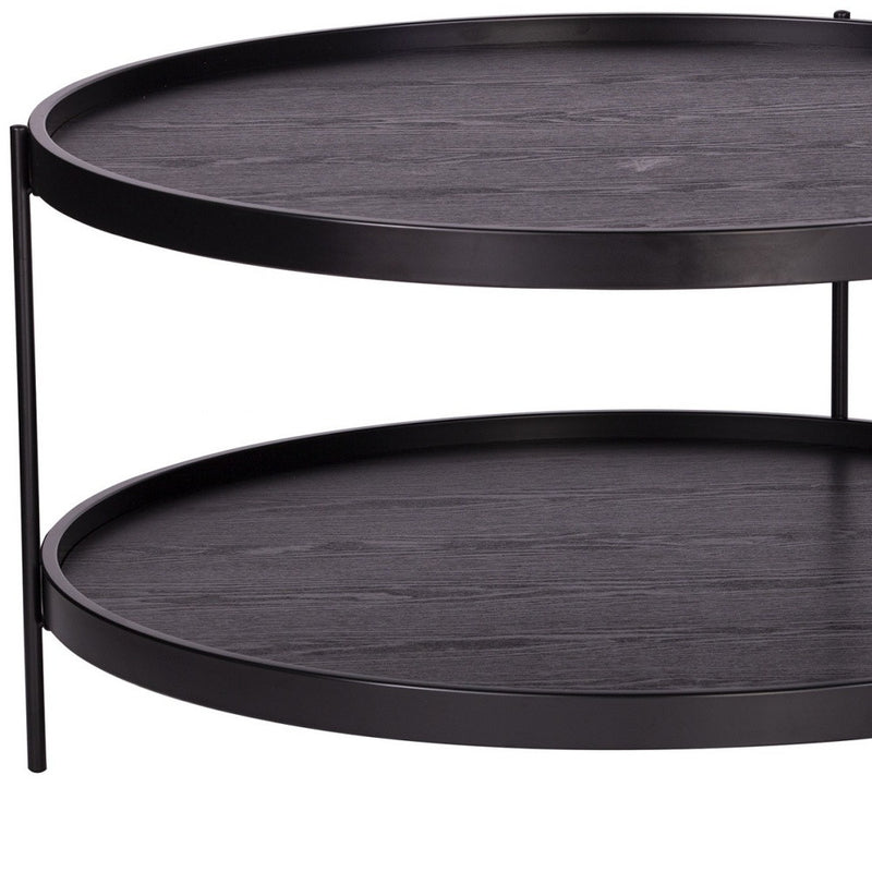Round coffee table side close-up, dark wood shelves with black metal support legs