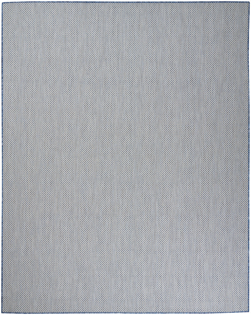 Light ivory indoor/outdoor area rug with textured speckled surface and thin border