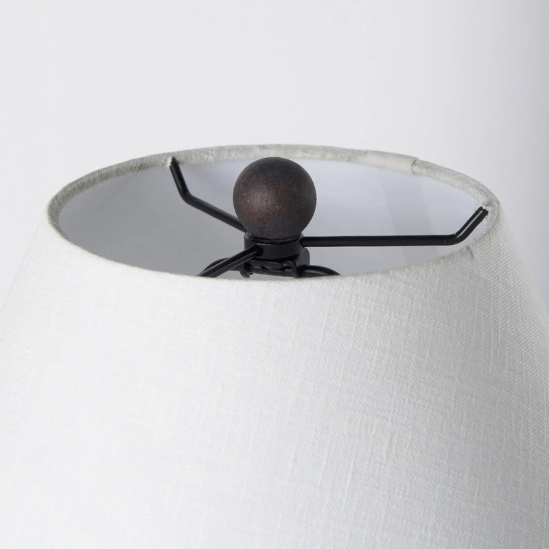 White textured lampshade with a black metal spider fitting and a round bronze finial top.