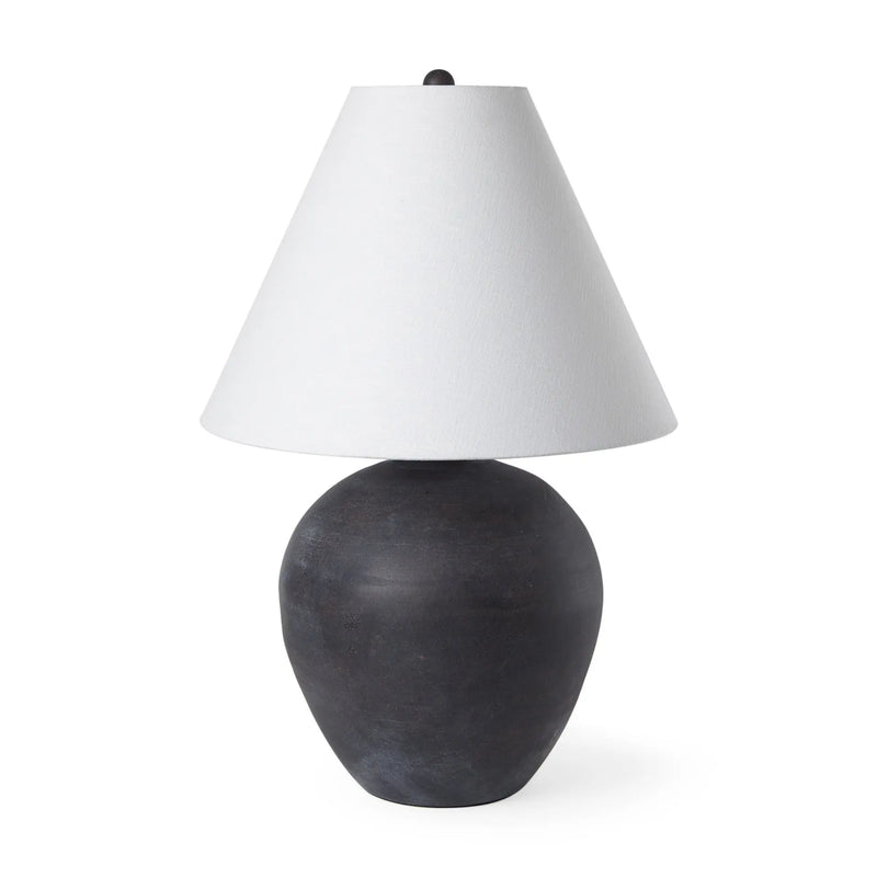 Black ceramic lamp with a textured finish and a white fabric cone shade. Elegant and modern design for home decor.