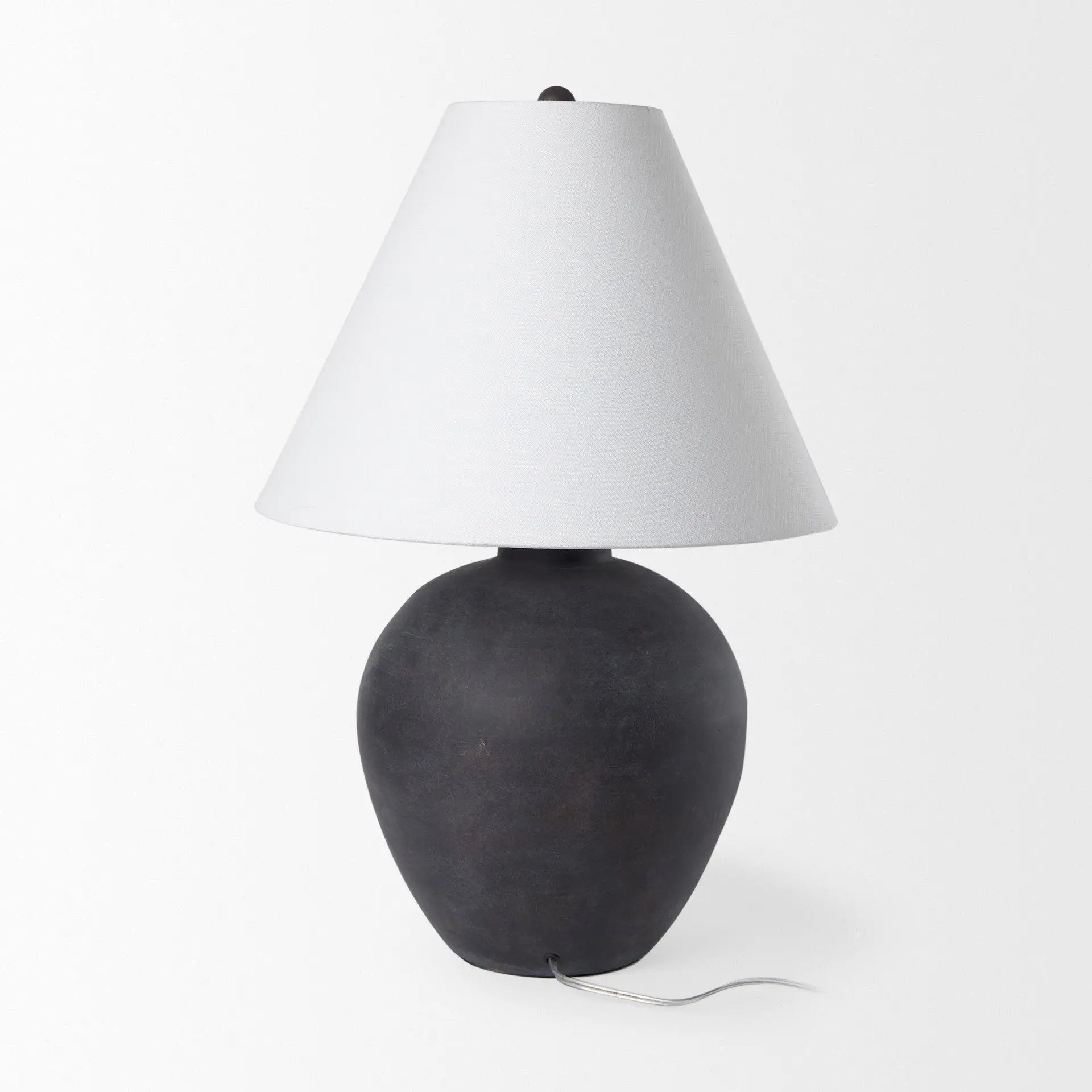 Black ceramic table lamp with a white fabric shade, featuring a contemporary vase silhouette.