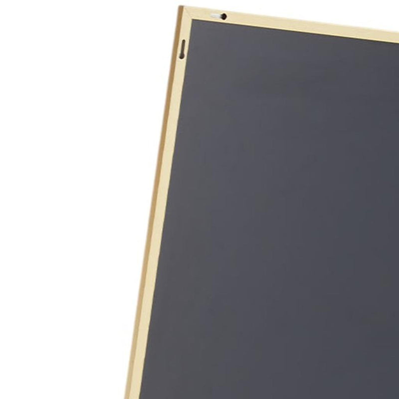 Gold metal-framed mirror with dark backing, close view of side edge and holes