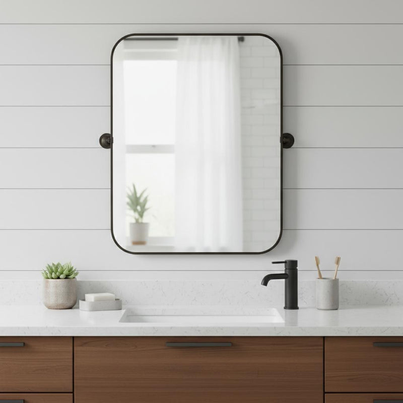 Black metal framed rounded-rectangle bathroom mirror with wall-mounted side brackets