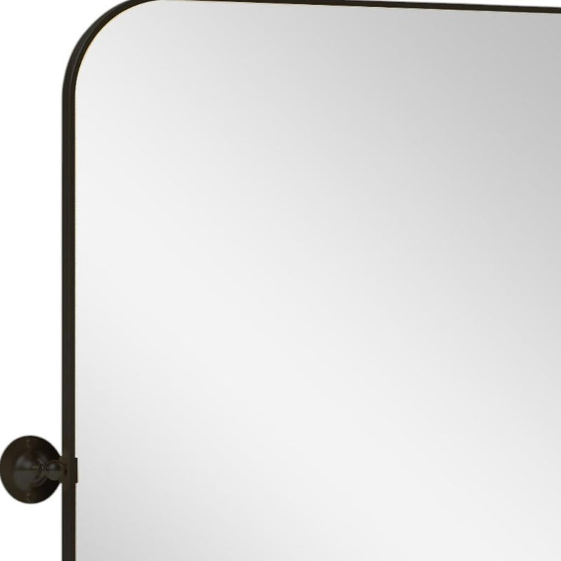 Black metal framed arched-top bathroom mirror with left circular mounting bracket