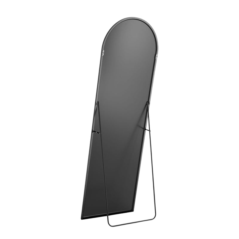 Dark arched standing mirror with black metal frame and curved top