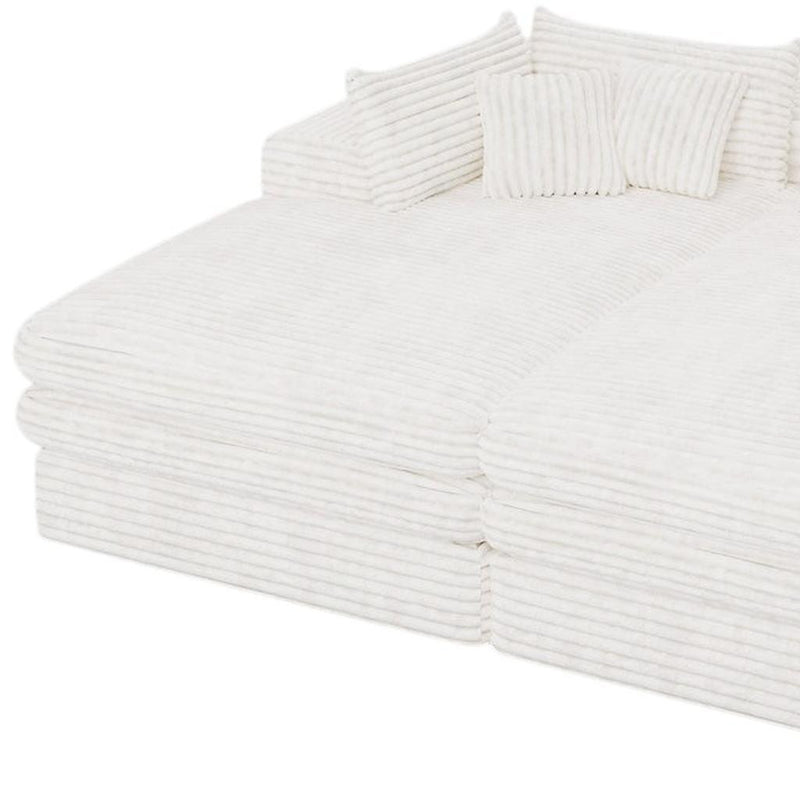 White corduroy chaise lounge with rolled arms and two toss pillows