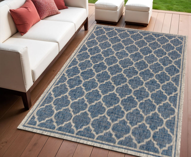Navy and gray geometric trellis area rug laid in a rectangular shape